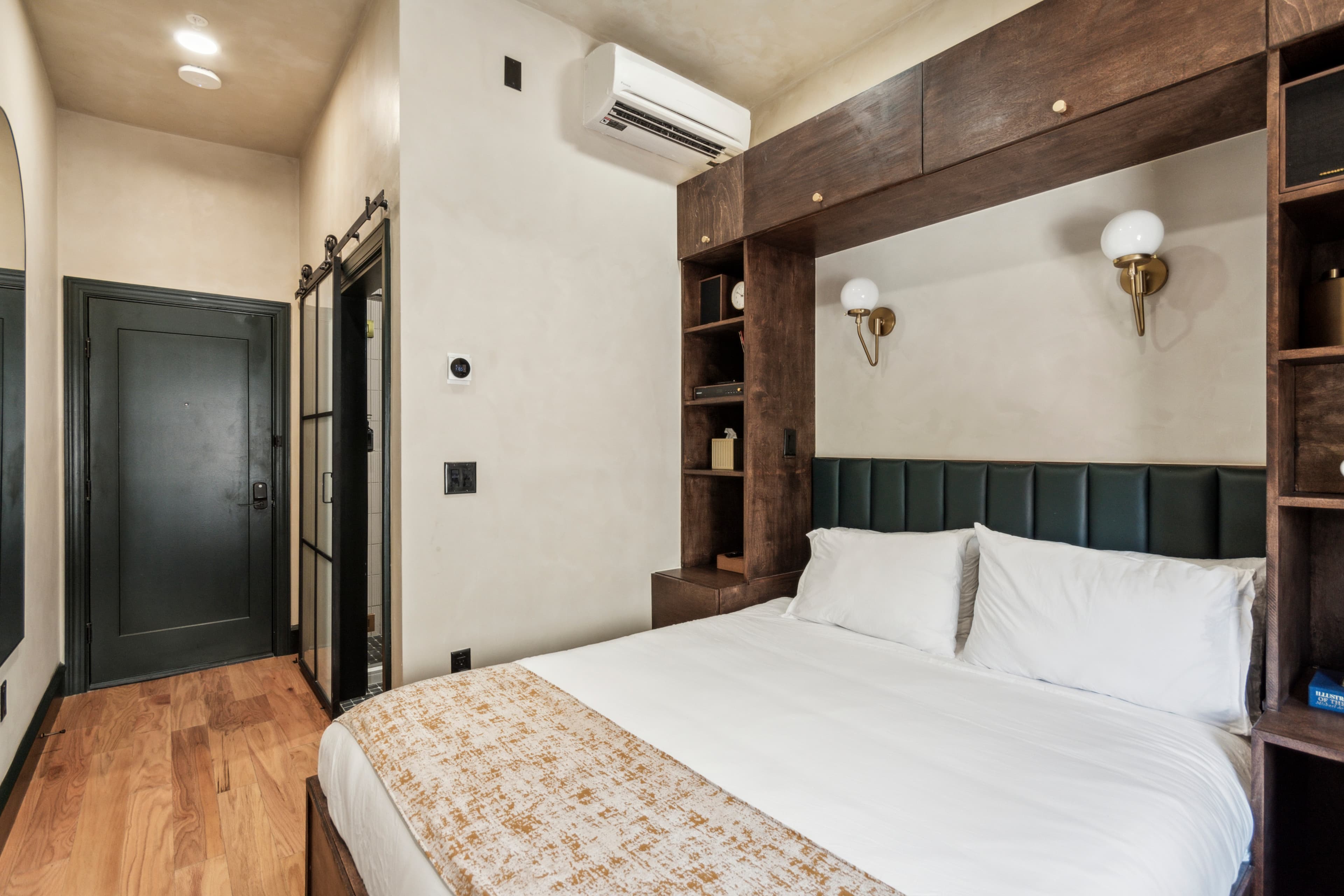 Queen room — bed and floral wallpaper